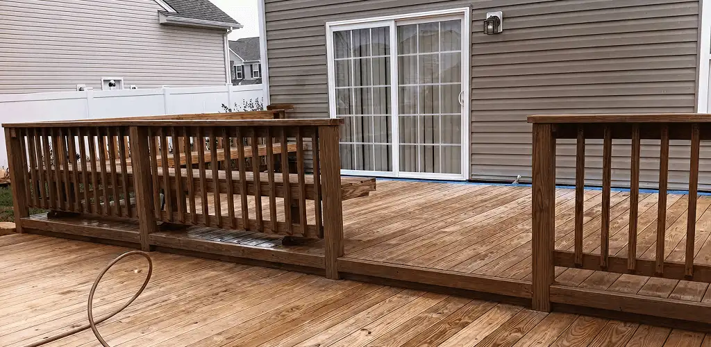 Deck sealing service protecting a backyard wood deck and railings in Staten Island, NY