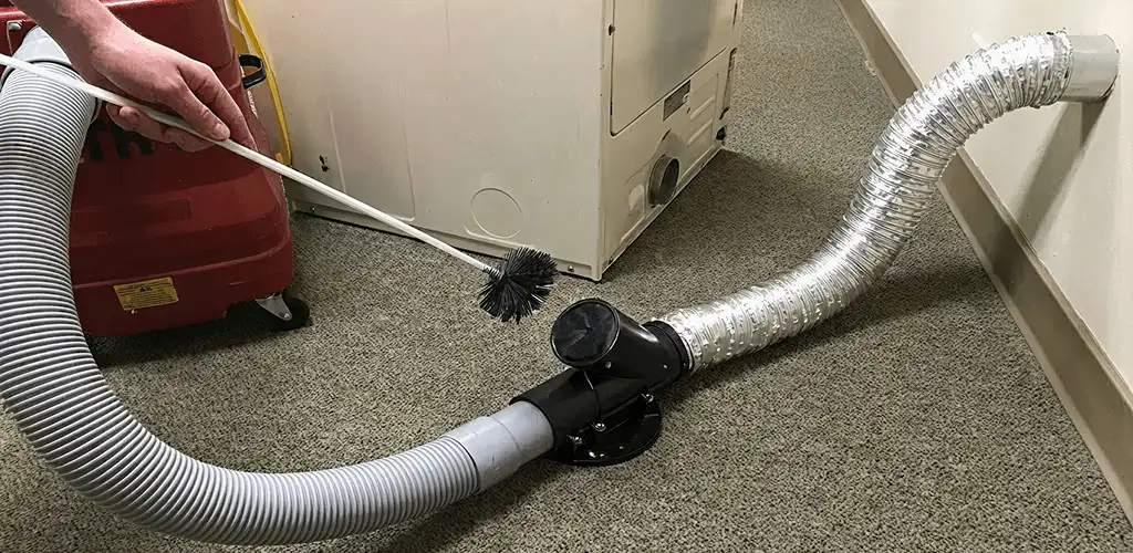 Dryer vent cleaning service removing lint from a dryer duct connection in Staten Island, NY