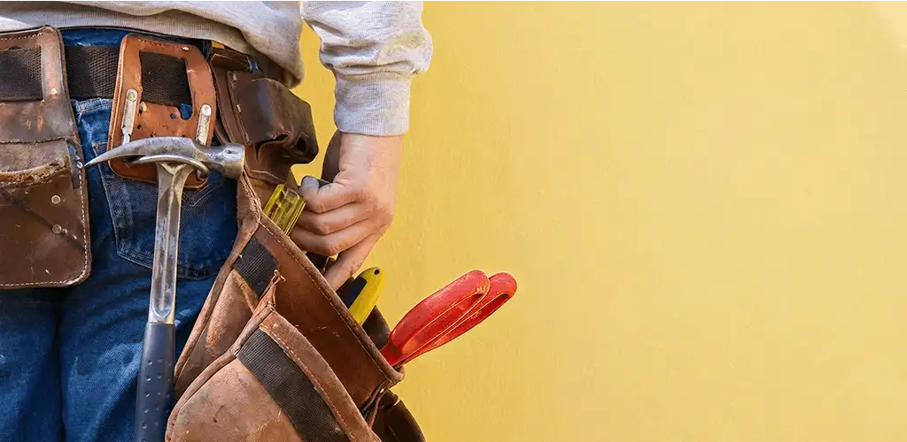 Handyman with tool belt ready for home repairs and maintenance in Staten Island, NY