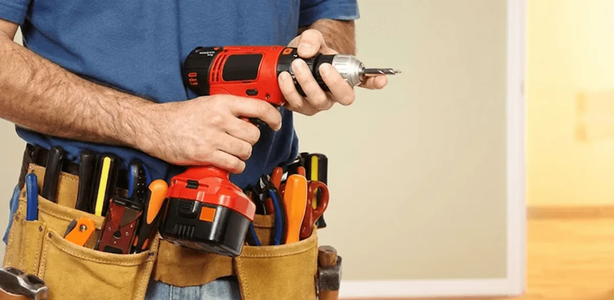 Handyman holding a power drill for home repairs and installations in Staten Island, NY