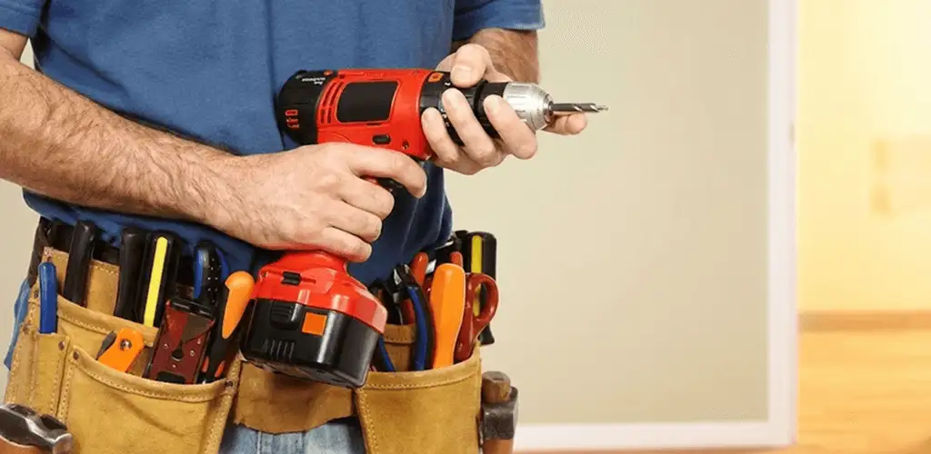 Handyman holding a power drill for home repairs and installations in Staten Island, NY