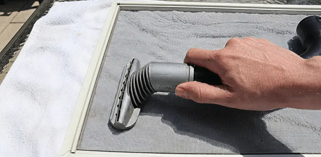 Window screen repair cleaning and fixing a damaged screen mesh in Staten Island, NY